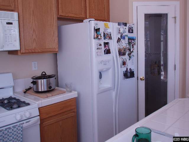 10437 Summershade Lane Reno, NV 89521 - Photo 4 of 9 a kitchen with stainless steel appliances granite countertop a refrigerator and a stove