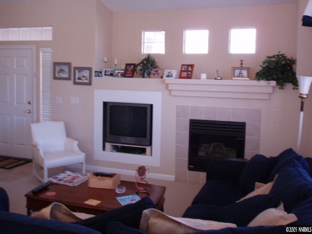 10437 Summershade Lane Reno, NV 89521 - Photo 5 of 9 a living room with furniture a flat screen tv and a fireplace