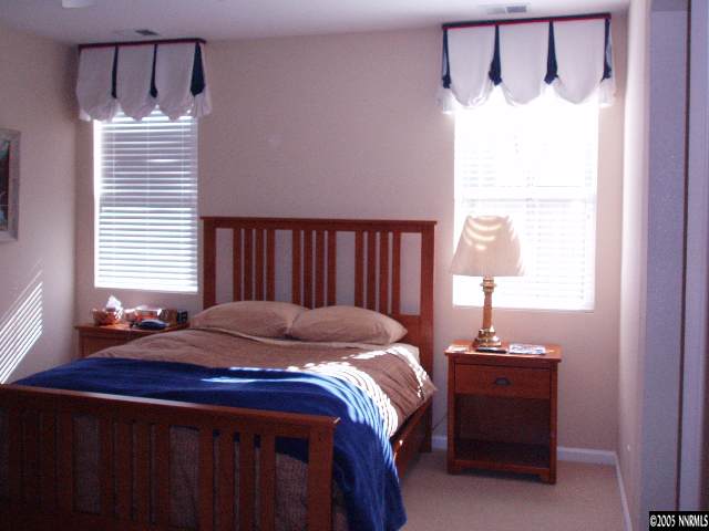 10437 Summershade Lane Reno, NV 89521 - Photo 7 of 9 a bed sitting in a bedroom next to a window