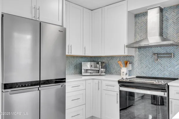 a kitchen with a refrigerator and cabinets