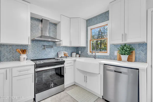 a kitchen with white cabinets and white appliances