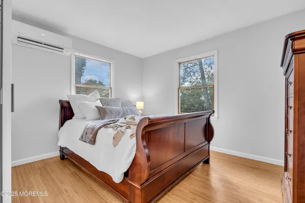 a bed sitting in a bedroom next to a window