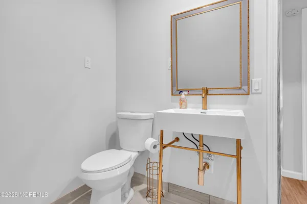 a bathroom with a sink mirror vanity and toilet