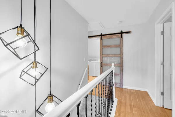 a view of staircase with railing and white walls