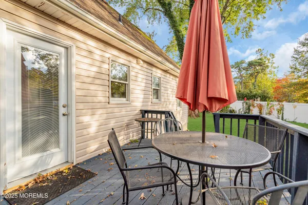a view of a balcony with a table and chairs