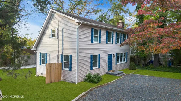a front view of house with yard and green space