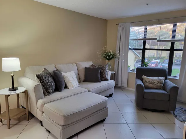 a living room with furniture and a lamp