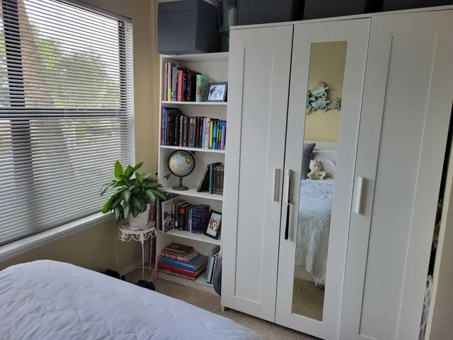 a living room with furniture and a book shelf