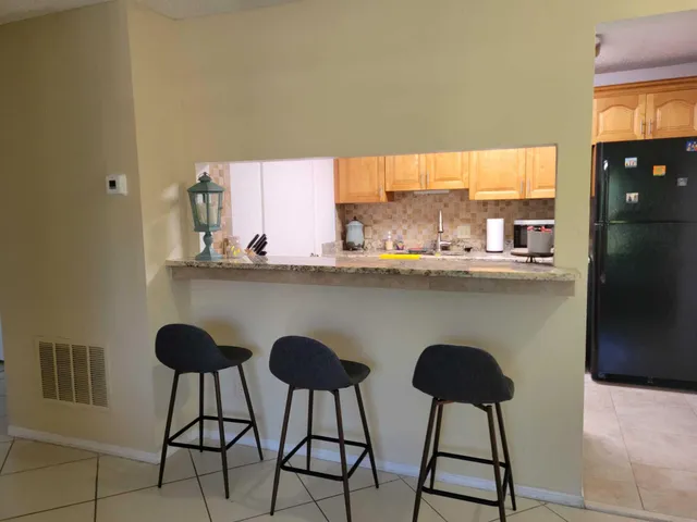 a kitchen with stainless steel appliances a counter space and a refrigerator
