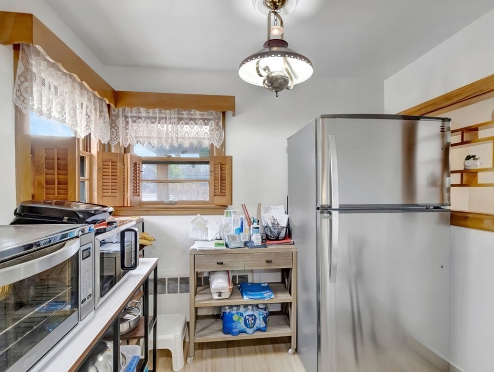 222 Walnut Street Saugus, MA 01906 - Photo 13 of 42 a kitchen with stainless steel appliances a stove a refrigerator and a dining table