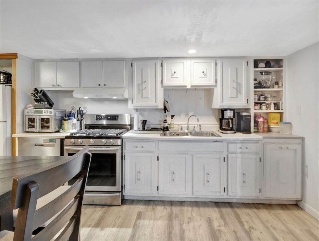 222 Walnut Street Saugus, MA 01906 - Photo 18 of 42 a kitchen with granite countertop white cabinets and stainless steel appliances