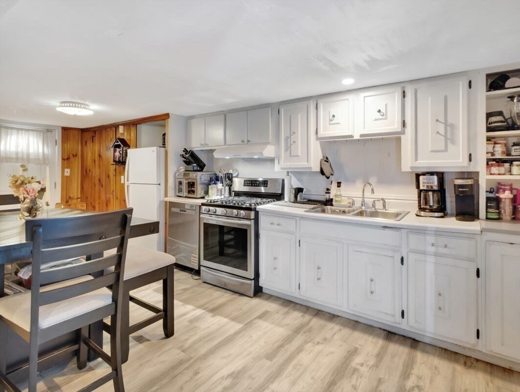 222 Walnut Street Saugus, MA 01906 - Photo 20 of 42 a kitchen with cabinets a sink and white stainless steel appliances
