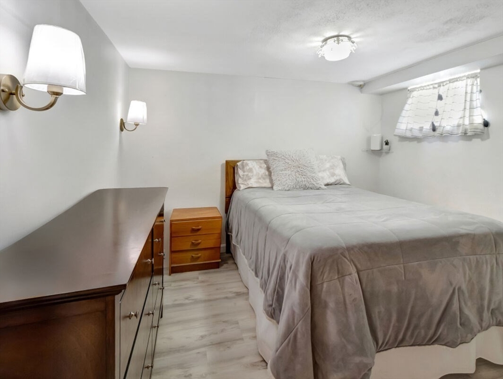 222 Walnut Street Saugus, MA 01906 - Photo 28 of 42 a bedroom with a bed and chandelier