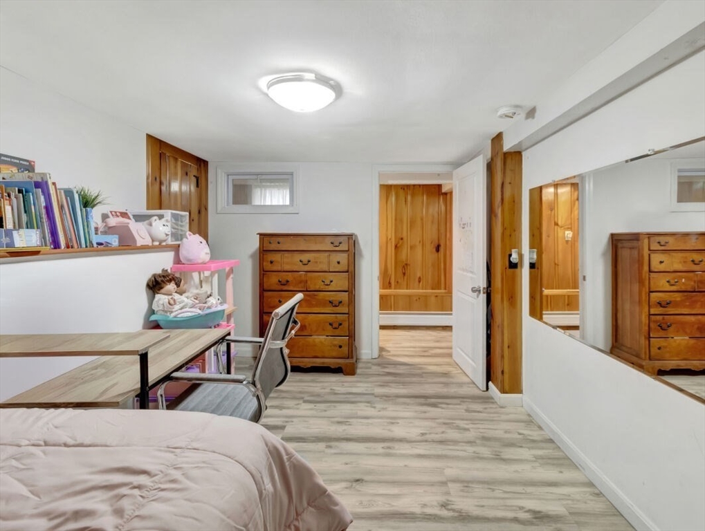 222 Walnut Street Saugus, MA 01906 - Photo 33 of 42 a bedroom with a bed and wooden floor