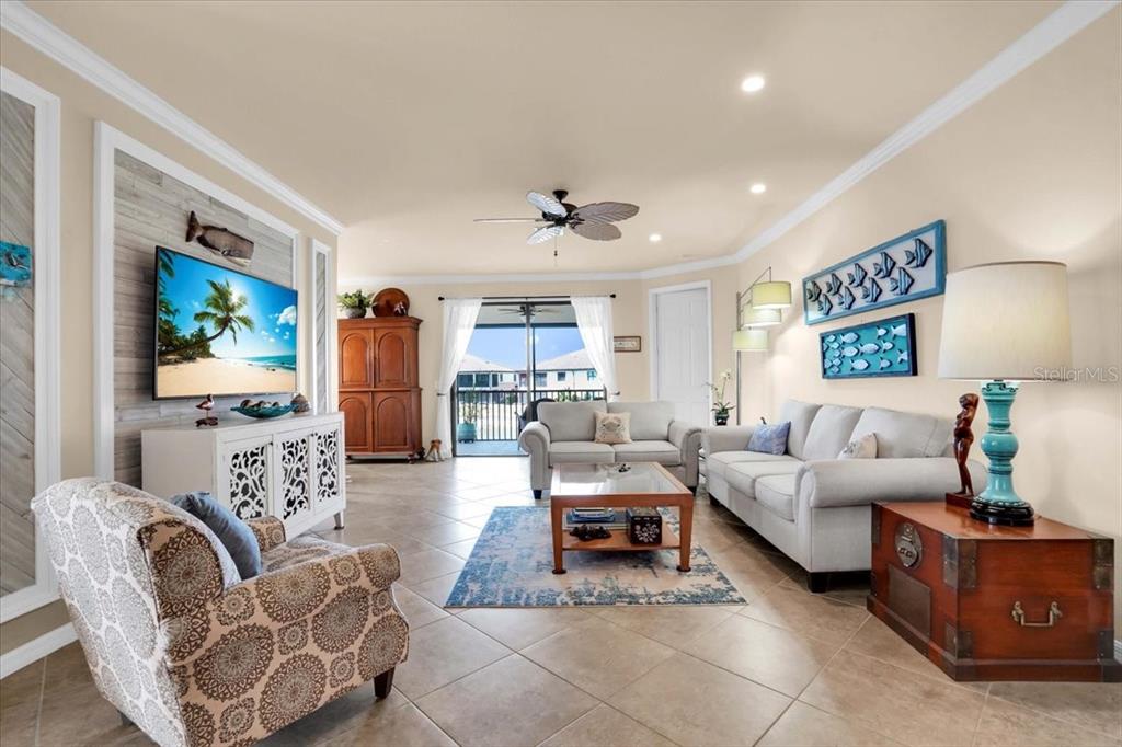 20201 Ragazza Circle, Unit 201 Venice, FL 34293 - Photo 14 of 58 a living room with furniture and a flat screen tv