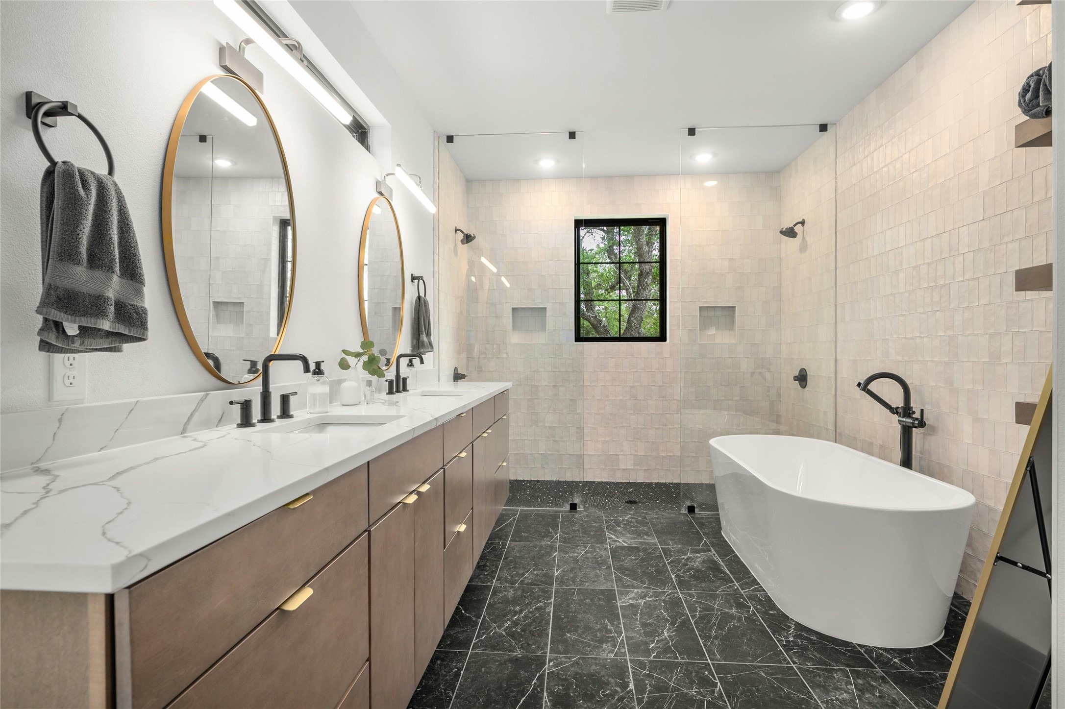 14302 Fallen Timber Drive Austin, TX 78734 - Photo 13 of 37 This bathroom features a double vanity with stone countertops and two oval mirrors