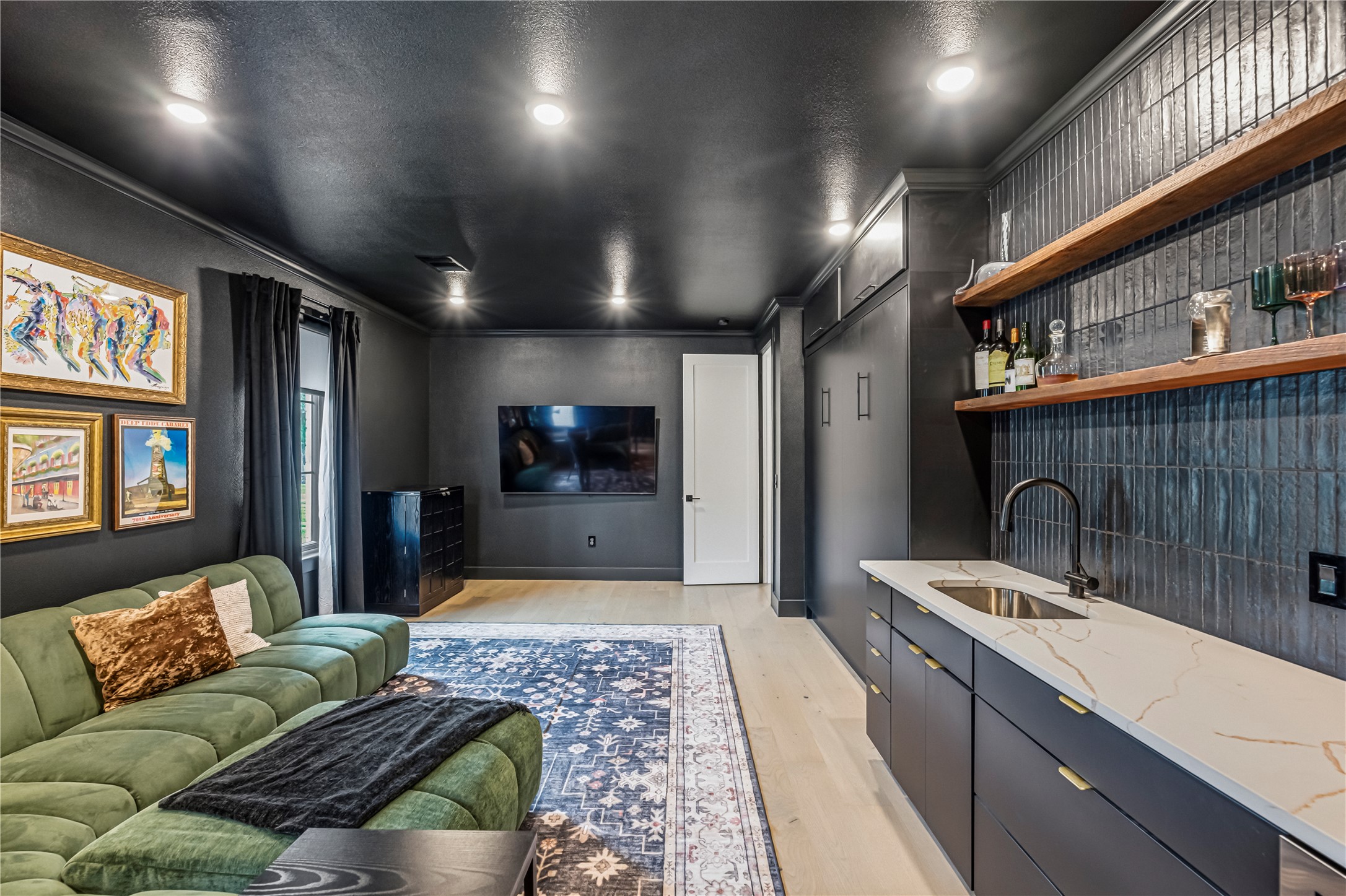 14302 Fallen Timber Drive Austin, TX 78734 - Photo 16 of 37 This refined interior space features light-colored flooring, a wet bar with a white countertop, and dark-toned cabinetry
