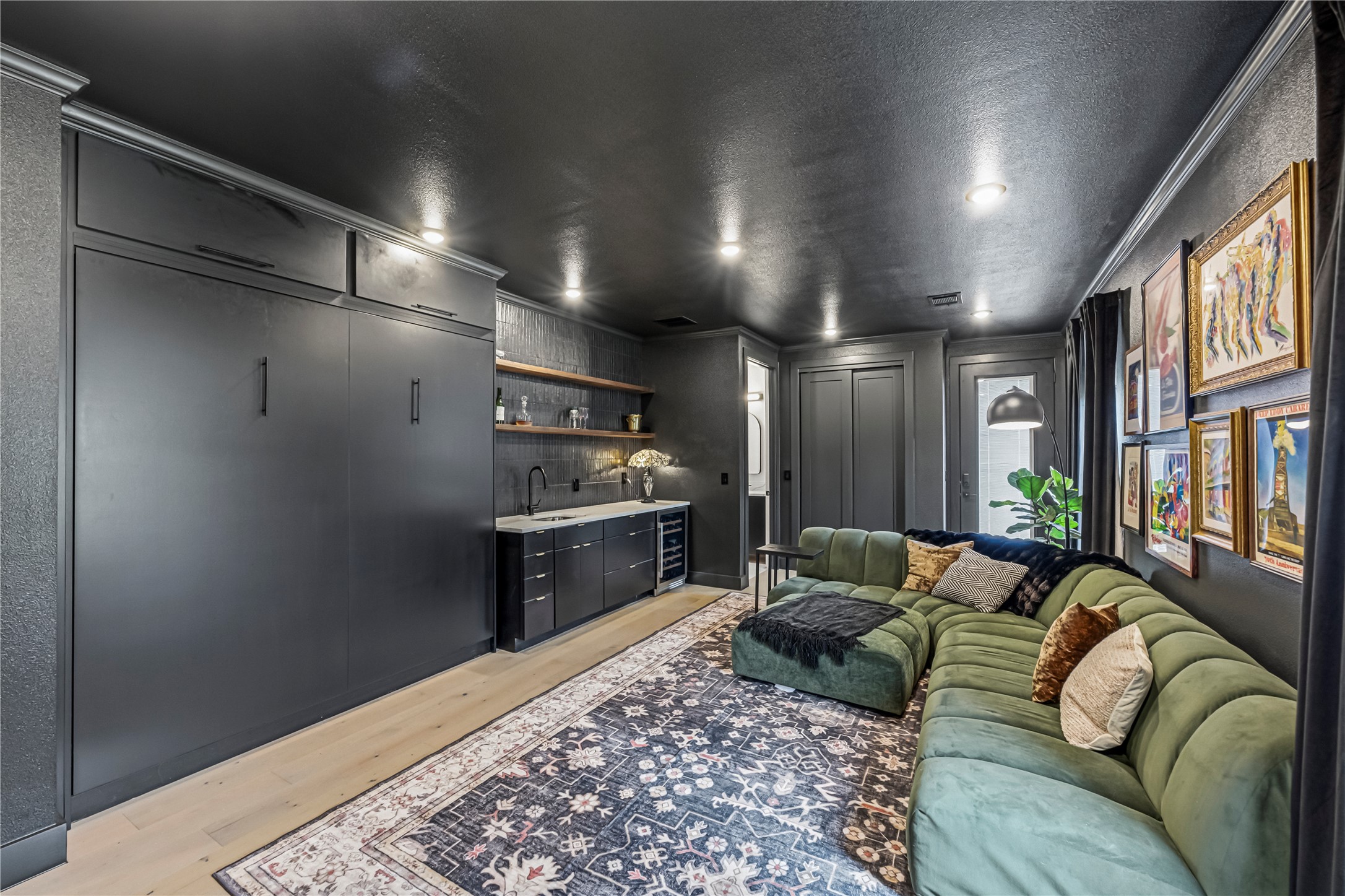 14302 Fallen Timber Drive Austin, TX 78734 - Photo 17 of 37 This versatile space features a built-in cabinet system, a wet bar with a sink and shelving, and recessed lighting