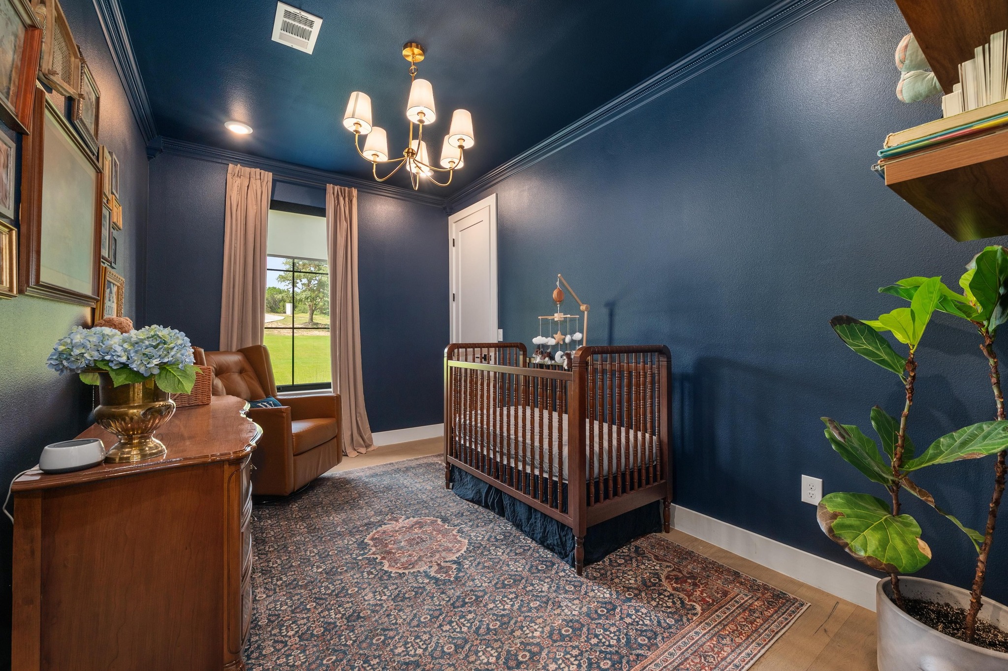 14302 Fallen Timber Drive Austin, TX 78734 - Photo 21 of 37 This room features rich blue walls with white crown molding, light wood floors, and a decorative area rug