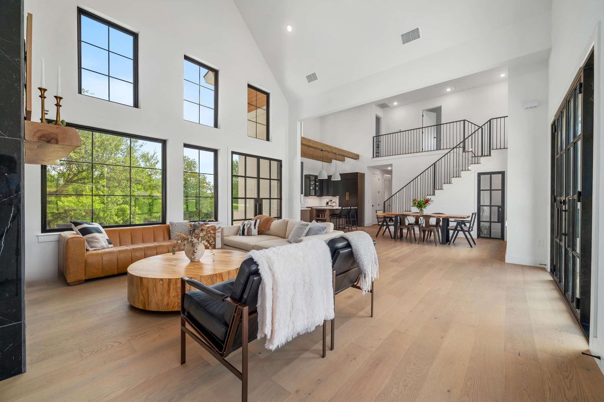 14302 Fallen Timber Drive Austin, TX 78734 - Photo 3 of 37 The property features soaring vaulted ceilings, large windows providing abundant natural light, and light wood flooring