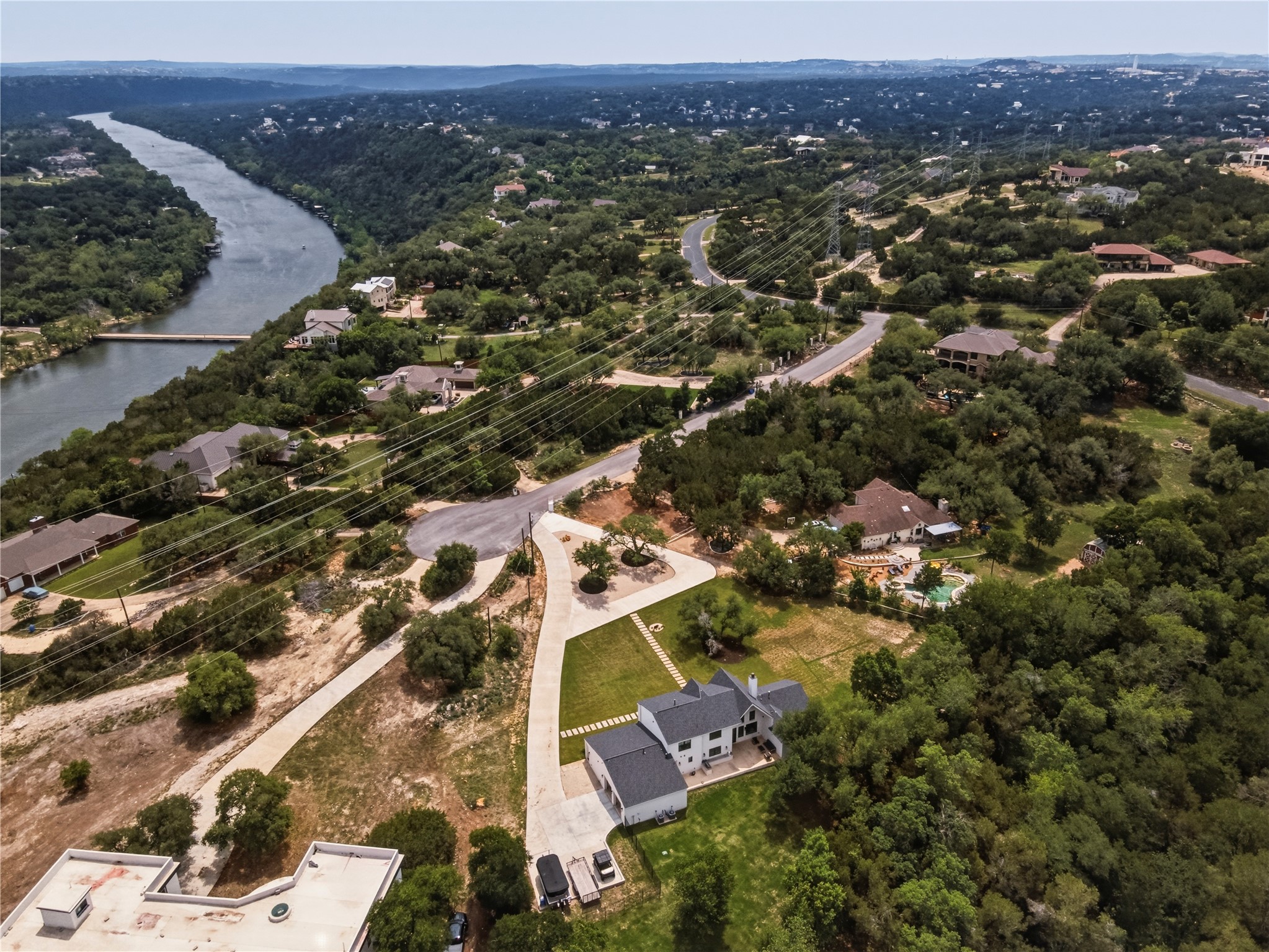 14302 Fallen Timber Drive Austin, TX 78734 - Photo 36 of 37 This property features a multi-story residence with a dark roof and light-colored siding, situated on a verdant lot