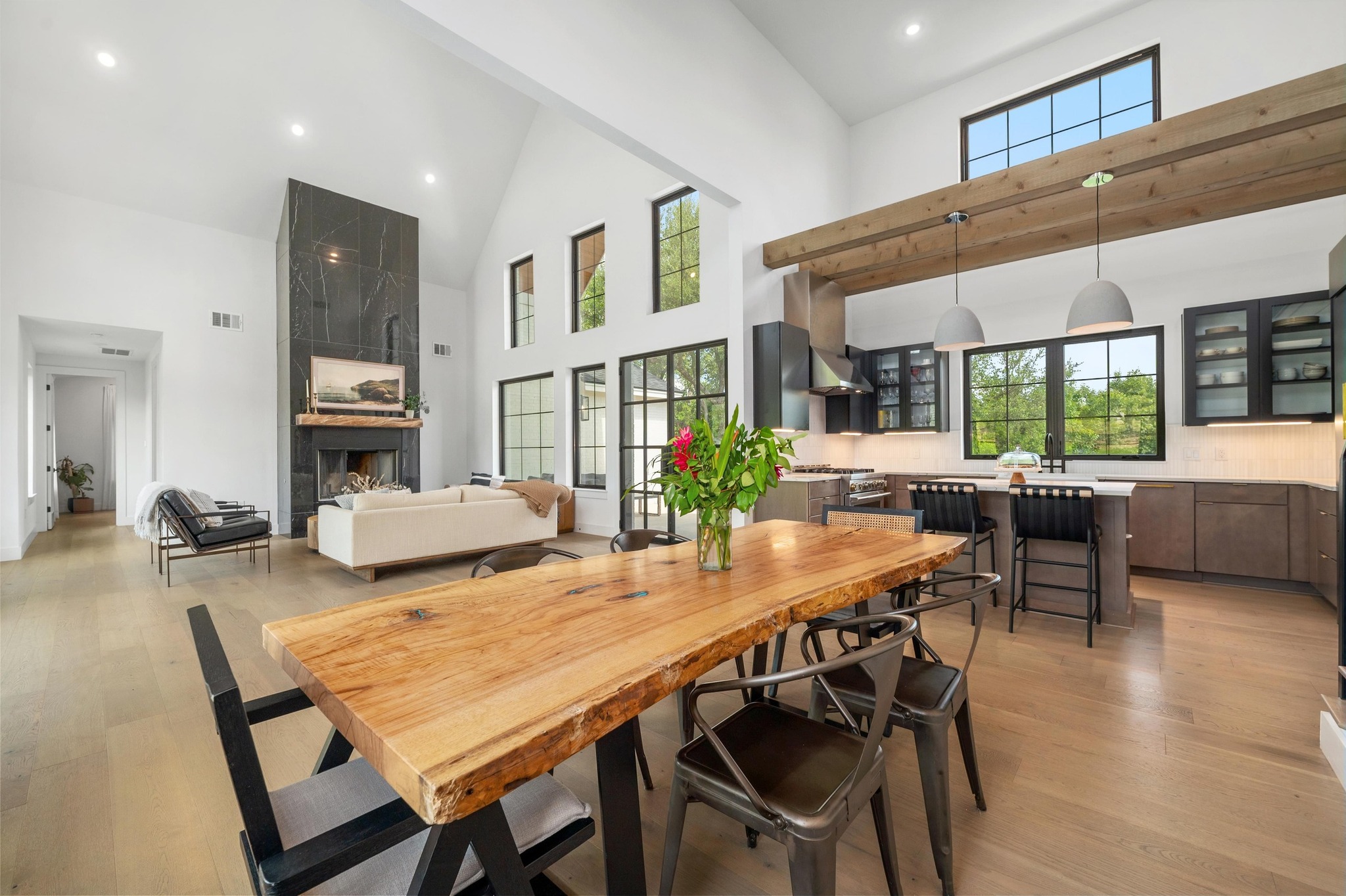 14302 Fallen Timber Drive Austin, TX 78734 - Photo 6 of 37 The property offers an open-concept living space with high vaulted ceilings, large windows providing abundant natural light, and light hardwood floors