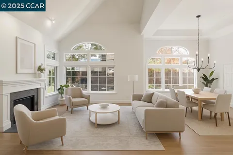 a living room with furniture a fireplace and a large window