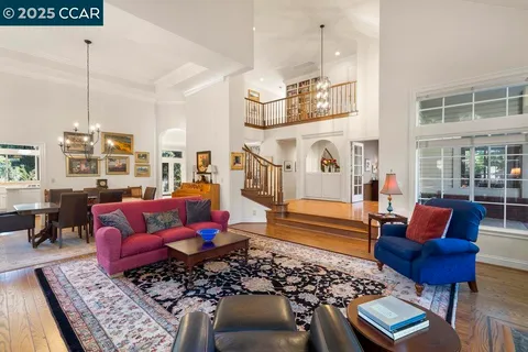 a living room with furniture rug and wooden floor