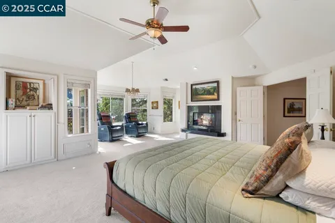 a spacious bedroom with a bed couch and a window