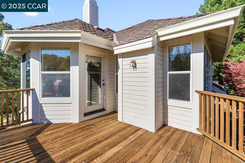 a view of balcony with wooden floor and fence