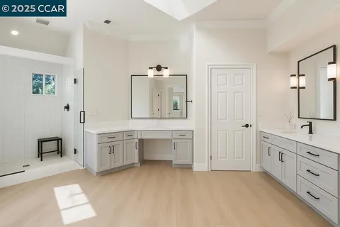 a large white kitchen with cabinets