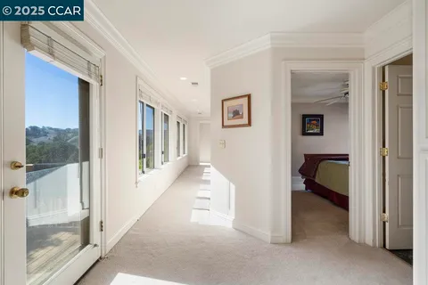 a living room with furniture a large window and a chandelier