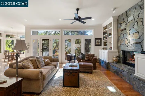 a living room with furniture ceiling fan and a rug