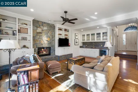 a living room with furniture a fireplace and a flat screen tv