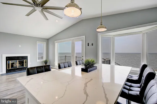 a large white bedroom with a bed and a chandelier