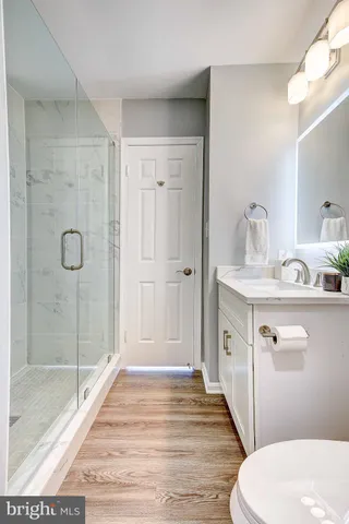 a bathroom with a sink a toilet and shower