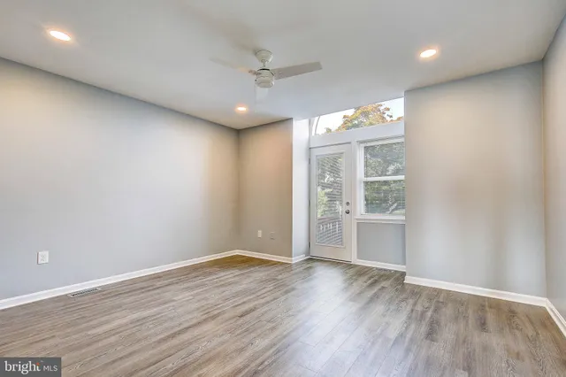 wooden floor in an empty room with a window