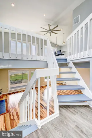 a view of entryway with wooden floor and stairs