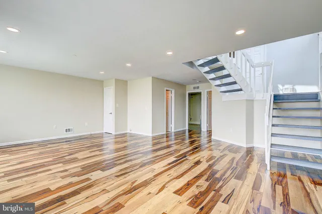 a view of a room with wooden floor and stairs