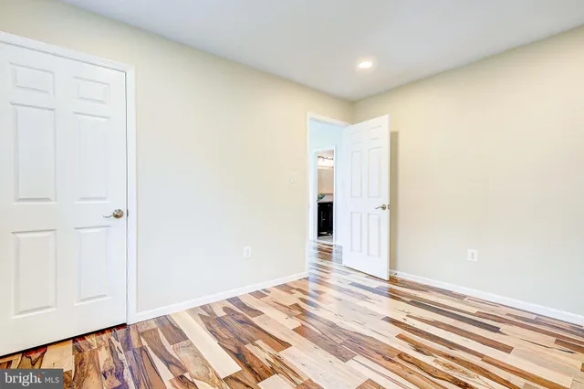 a view of a room with wooden floor