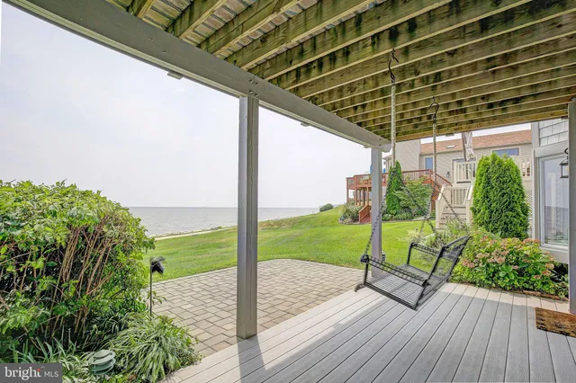 a view of a porch with furniture and garden