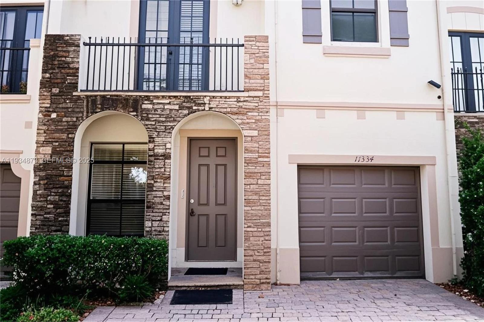 11334 Southwest 236th Street, Unit 11334 Homestead, FL 33032 - Photo 1 of 25 a front view of a house with a door and pathway