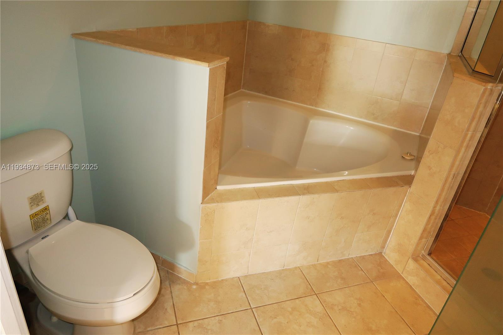 11334 Southwest 236th Street, Unit 11334 Homestead, FL 33032 - Photo 16 of 25 a bathroom with a toilet and a shower