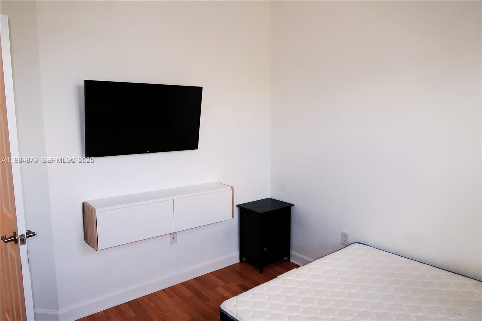 11334 Southwest 236th Street, Unit 11334 Homestead, FL 33032 - Photo 19 of 25 a living room with a flat screen tv