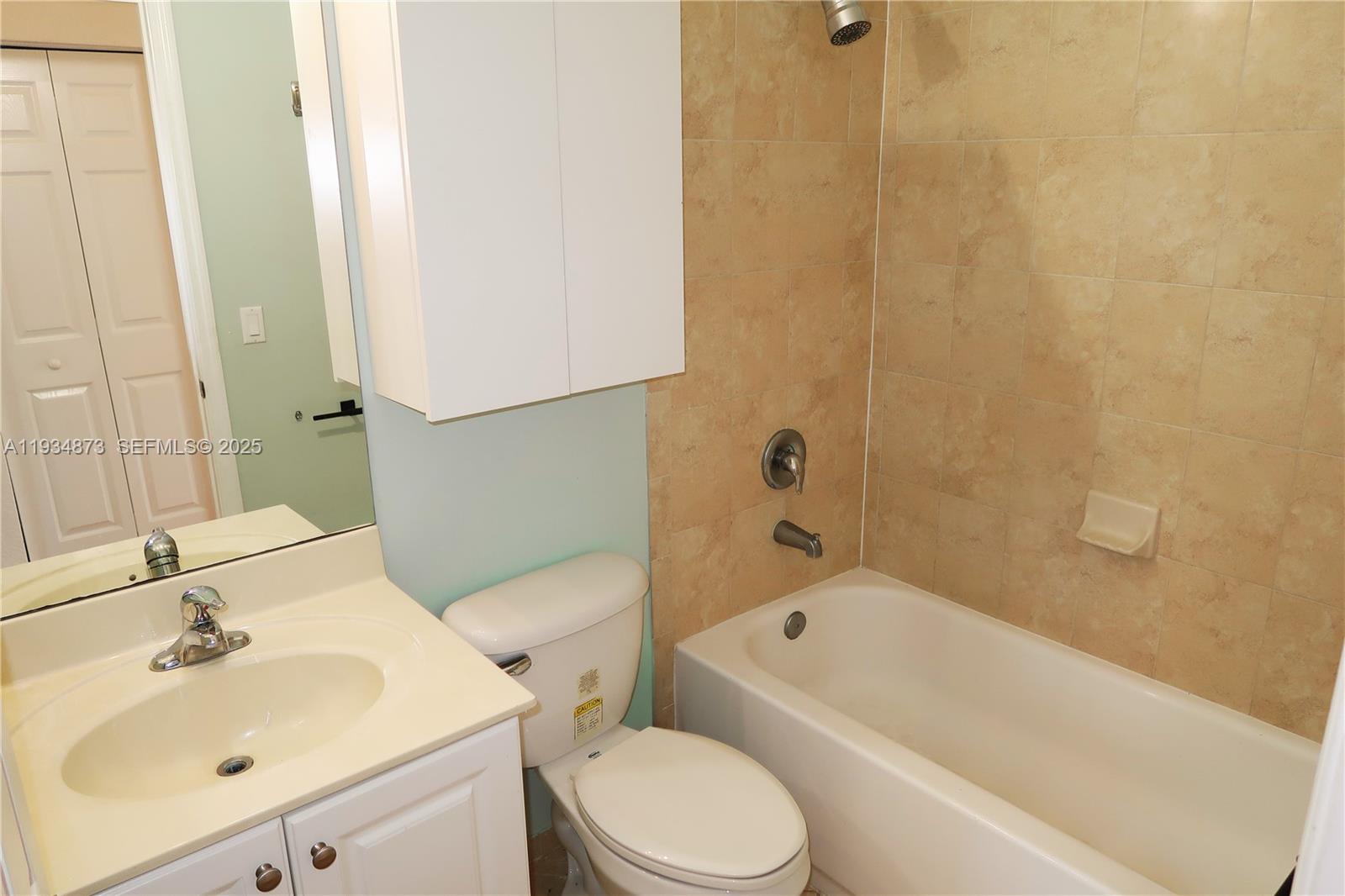 11334 Southwest 236th Street, Unit 11334 Homestead, FL 33032 - Photo 20 of 25 a bathroom with a sink toilet and shower