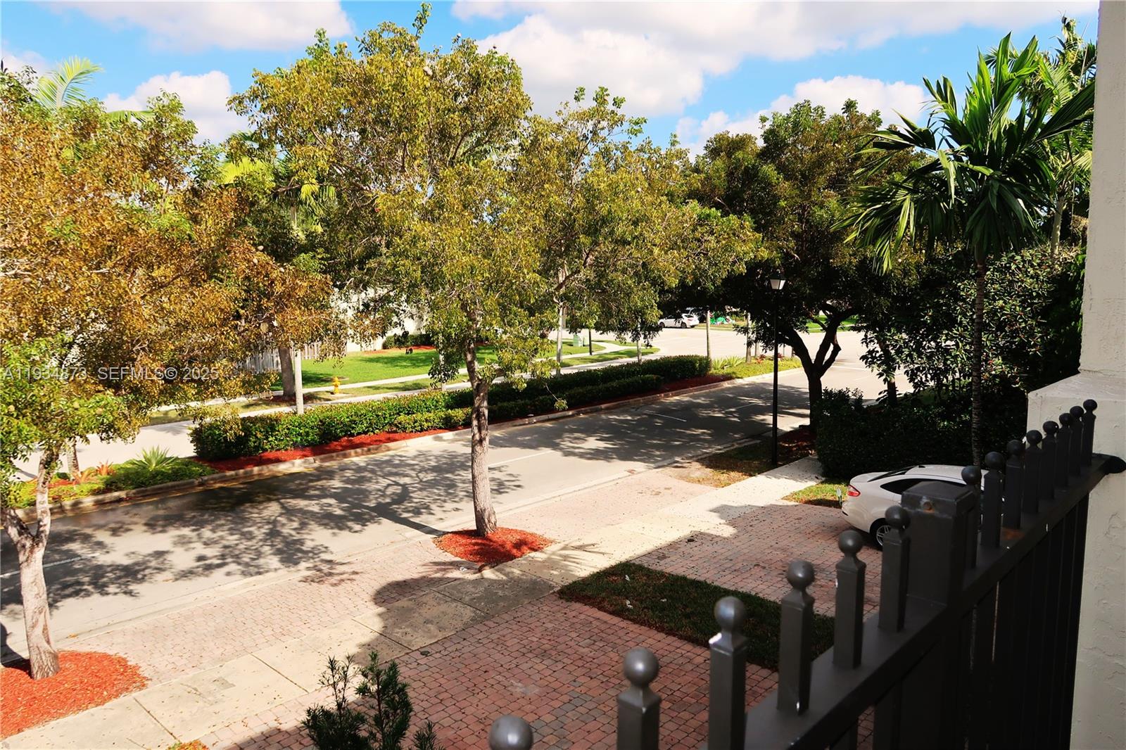 11334 Southwest 236th Street, Unit 11334 Homestead, FL 33032 - Photo 24 of 25 a street view with large trees
