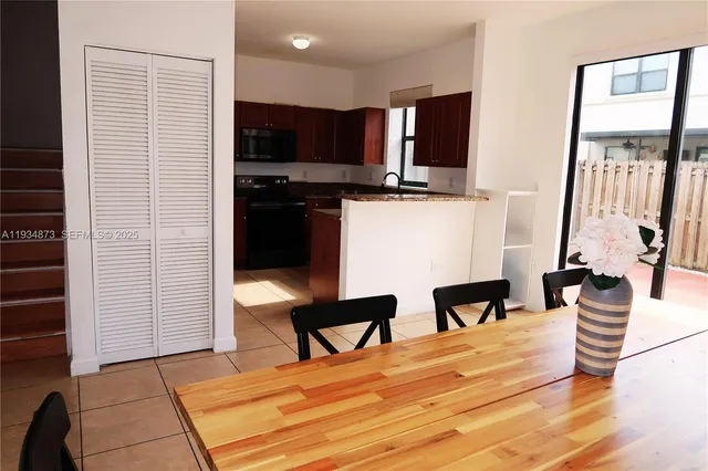 a hotel room with chair and wooden floor