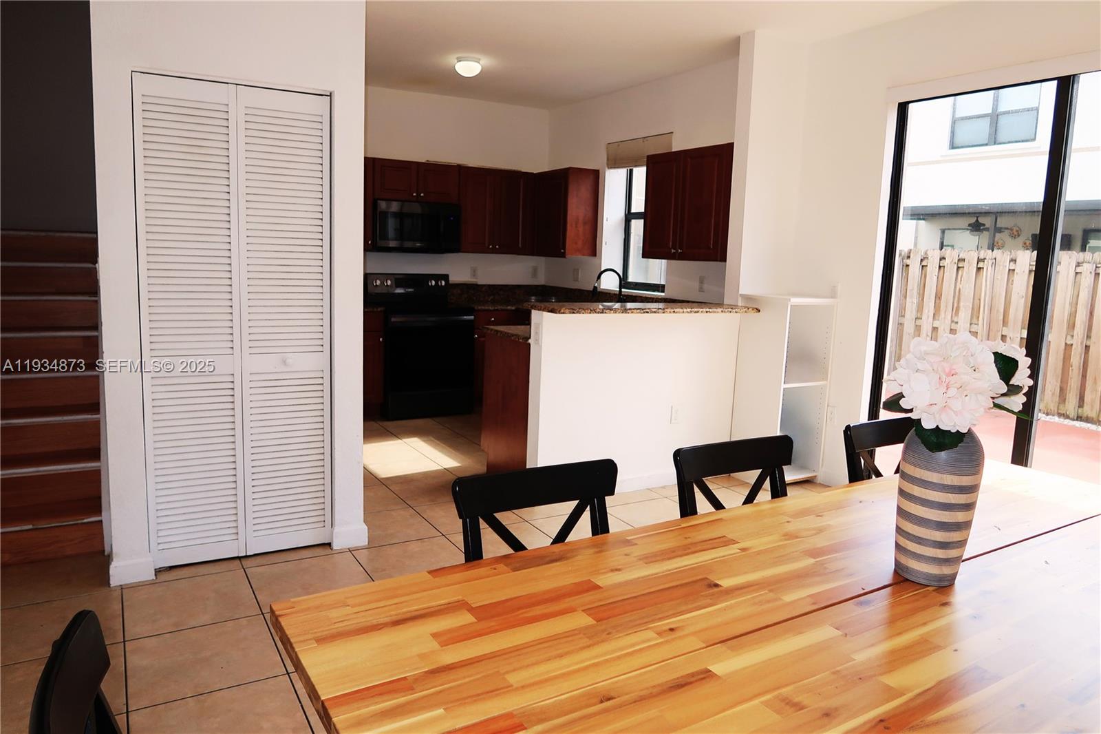 11334 Southwest 236th Street, Unit 11334 Homestead, FL 33032 - Photo 7 of 25 a hotel room with chair and wooden floor