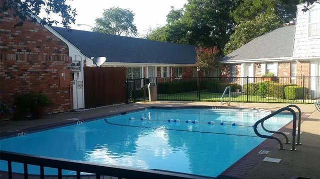 a view of house with a swimming pool