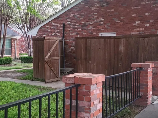 a view of a roof deck with wooden fence and wooden stairs